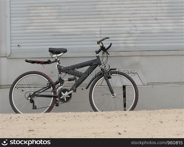 old mountain bike standing on the beach