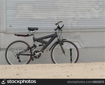 old mountain bike standing on the beach