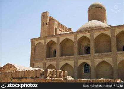 Old multi-storey building with dome, subject to restoration. the ancient buildings of medieval Asia. Ancient architecture of Central Asia and East