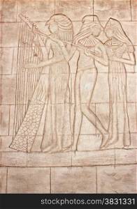 Old murals. Frieze of Egyptian Goddess. Wall carving.