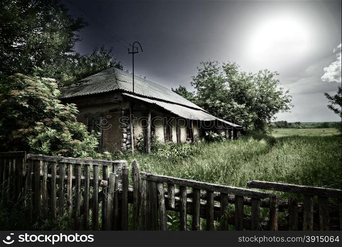 Old mysterious abandoned house under dramatic lighting