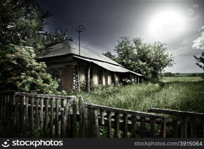 Old mysterious abandoned house under dramatic lighting