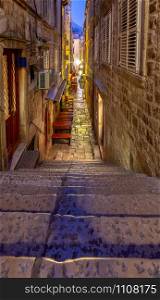 Old narrow medieval street in the historical part of the city at night. Dubrovnik. Croatia.. Dubrovnik. Old narrow traditional city street.
