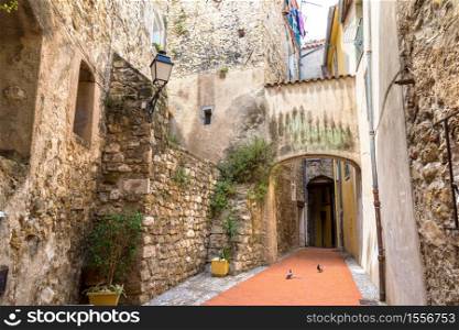Old narrow street in Menton on french Riviera in a beautiful summer day, France