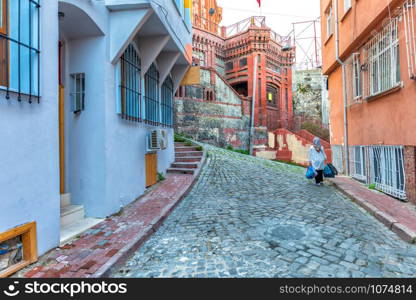 Old narrow street of Fener and a Turkish lady, Istanbul.. Old narrow street of Fener and a Turkish lady, Istanbul