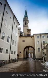Old narrow street with catholic church at Salzburg