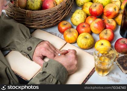 old notebook with a basket of apples and bottles of cider