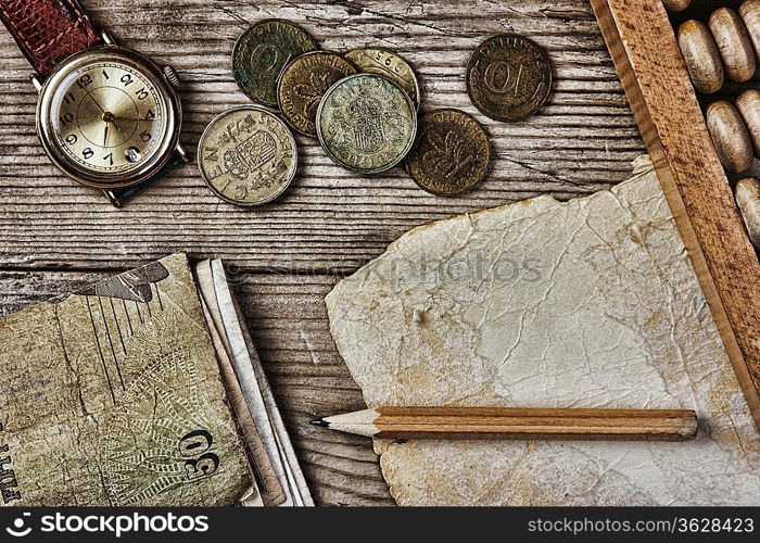 Old notes and coins and abacus on a wooden table