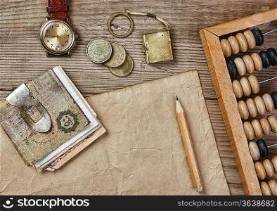 Old notes and coins and abacus on a wooden table