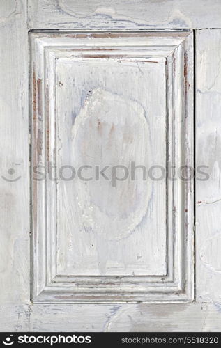 Old painted wood background with frame. Old distressed wood door panel with peeling paint as framed background