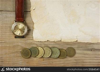 Old paper and coins on a wooden table
