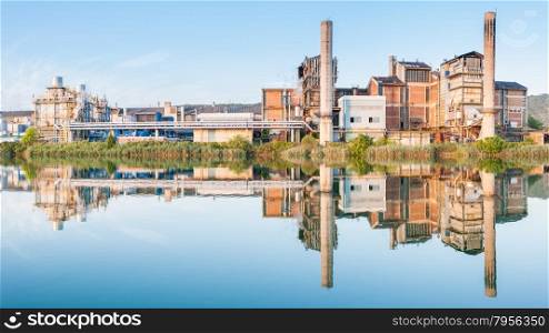 Old paper factory that is reflected in the river