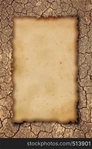 old paper on dry cracked earth background