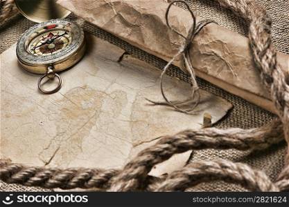old paper with compass and rope on canvas