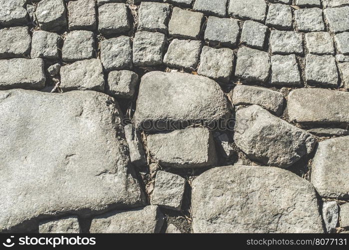 Old paved road and big stones