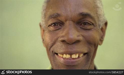 Old people and emotions, portrait of senior african american man looking and smiling at camera. Sequence