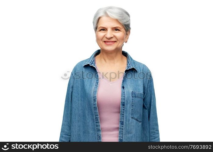 old people concept - portrait of smiling senior woman in denim shirt over white background. portrait of smiling senior woman in denim shirt