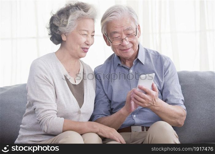 Old people in the East using a mobile phone