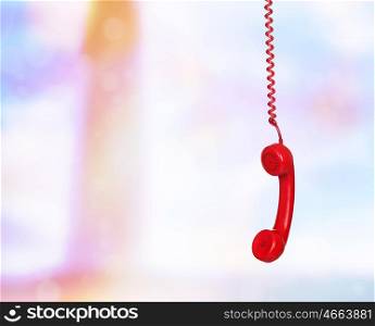 Old phone hanging wire on unfocused background