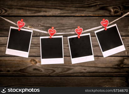 Old photo frames on wood background. Valentines message.