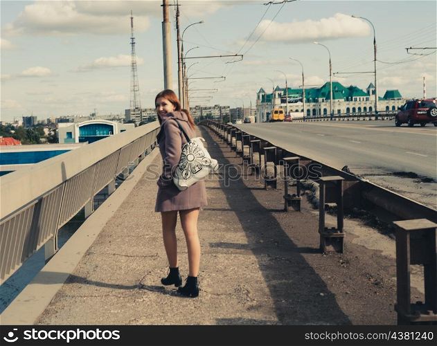 old photo of young women walk on bridge. Vintage looking image