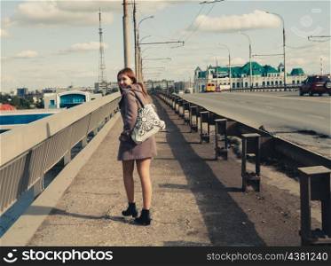 old photo of young women walk on bridge. Vintage looking image