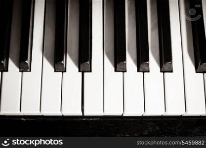 Old piano keyboard close up as a music background. Black and white image