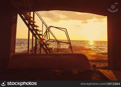 Old pier at sunset, tinted orange