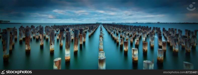 Old Pier Stumps in the blue sea water of Port Melbourne, Australia. Oat Vaiyaboon