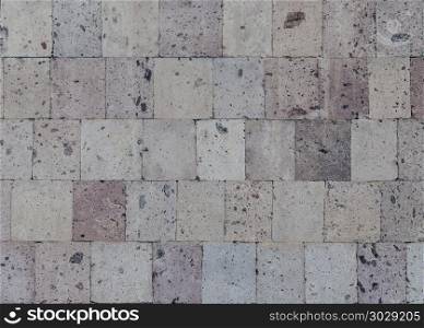 Old pink tuff tiles wall background. Wall of pink tuff tiles