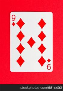 Old playing card (nine) isolated on a red background