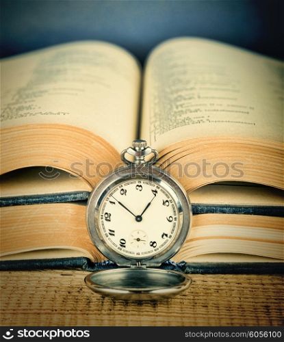 Old pocket watch and an open book