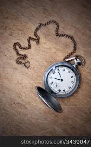 old pocket watch on a wooden background