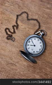 old pocket watch on a wooden background