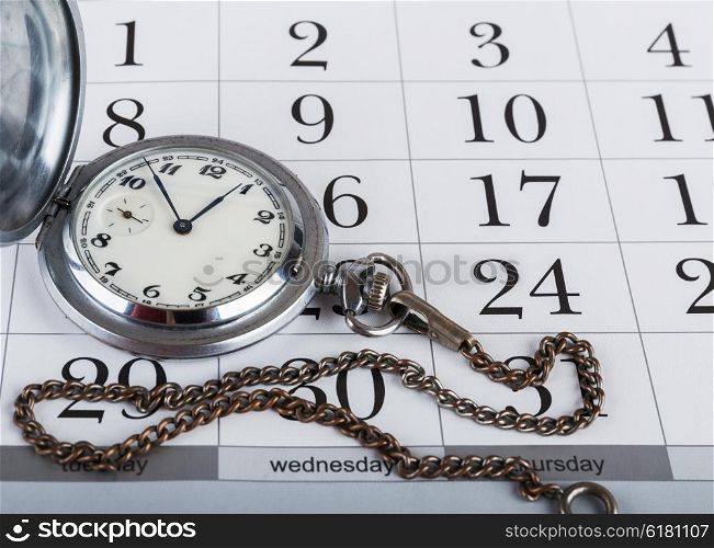 Old pocket watch on the calendar