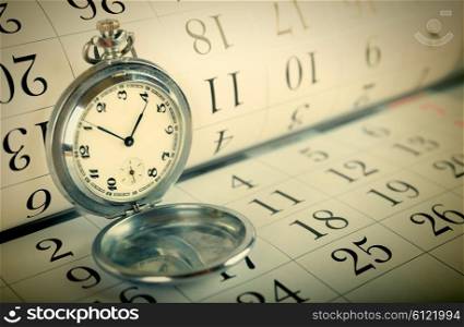 Old pocket watch on the calendar. Toned