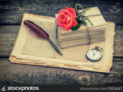 Old postcards and letters with red rose flower. Retro style toned picture