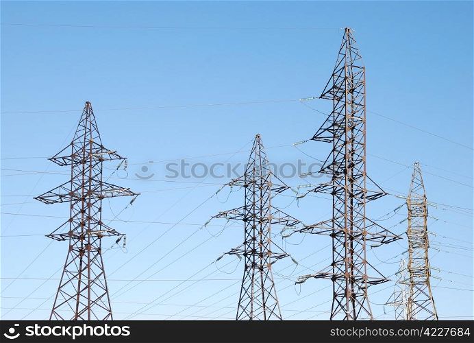 Old power lines on the blue sky background. Power lines