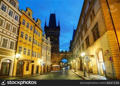 Old Prague street with Charles bridge in the morning