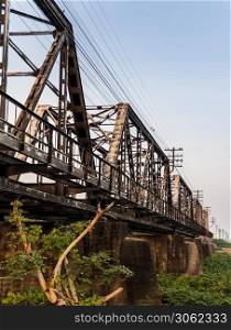 Old railroad tracks on Black Bridge or Lampang Railway Bridge. Railway bridge on river at Lampang thailand. No focus, specifically.
