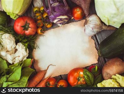 Old recipe on the table with vegetables with copy space. Vegetables on wooden table