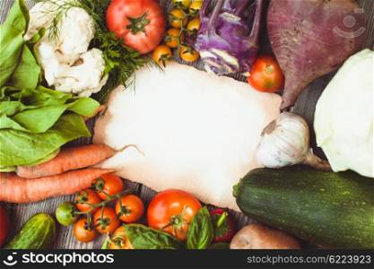 Old recipe on the table with vegetables with copy space. Vegetables on wooden table