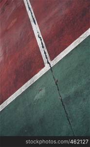old red and green tennis court ground in the street