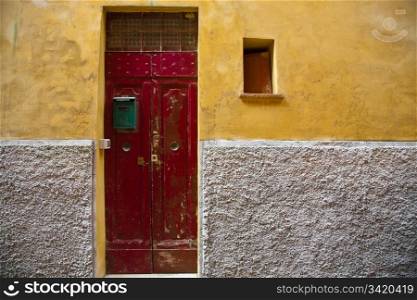 Old Red Door. Red Door and Yellow Wall. Old Italy Series.