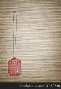Old red swatter on the wall - copy space