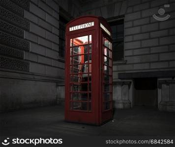 old red telephone booth at night in london on pavement near old building
