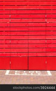 Old red wooden panels as background or texture. Fire exit sign.. Red wooden background or texture. Fire exit sign.