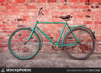 Old retro bicycle against brick wall