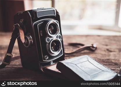 Old retro camera on old wooden background