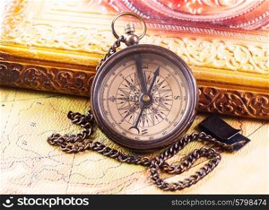 old retro compass on vintage map
